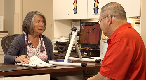 Photo image of a Veteran meeting with a VA health care provider.